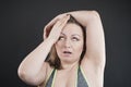 Unhappy woman shows her unshaved armpit. plus size middle age woman is not happy with hair in her armpits. Caucasian girl is Royalty Free Stock Photo