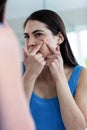 Unhappy woman with skin irritation cleaning her face Royalty Free Stock Photo