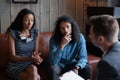 Unhappy young African American man and woman visiting psychologist Royalty Free Stock Photo