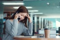 Unhappy young asian woman talking on mobile phone while reading book in library Royalty Free Stock Photo