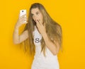 Unhappy young attractive woman very surprised something on her smartphone Royalty Free Stock Photo