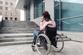 Unhappy young black woman suffering from lack of wheelchair friendly facilities, cannot get home without ramp, copy Royalty Free Stock Photo