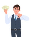 Unhappy young business man in waistcoat showing cash, money and gesturing thumbs down sign. Trendy person holding currency notes. Royalty Free Stock Photo