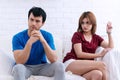 Unhappy couple after find out positive pregnancy test in living room. Not readily available to families. Young woman holding Royalty Free Stock Photo