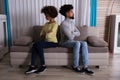 Unhappy Couple Sitting Back To Back On Sofa Royalty Free Stock Photo