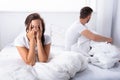 Unhappy Couple Sitting On Bed Royalty Free Stock Photo