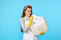 caucasian woman in rubber gloves smelling laundry on Royalty Free Stock Photo