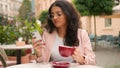 Unhappy young Indian Arabian ethnic woman female girl drinking coffee feel annoyed negative message notification mobile
