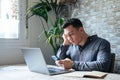 Unhappy young man looking at phone, feeling nervous of bad device work, internet disconnection, lost data or inappropriate online