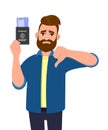 Unhappy young man showing passport tickets and gesturing thumbs down sign. Trendy hipster person holding boarding pass. Travel