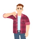 Unhappy young man showing thumbs down sign. Trendy person making dislike, bad or negative gesture with hand. Stylish male. Royalty Free Stock Photo