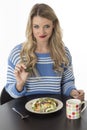 Unhappy Young Woman Eating Mixed Vegetables Meal Royalty Free Stock Photo