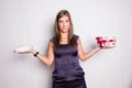 Unhappy young woman holding gift box Royalty Free Stock Photo