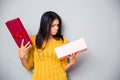 Unhappy young woman holding gift box Royalty Free Stock Photo