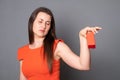 Unhappy young woman holding gift box on gray background Royalty Free Stock Photo