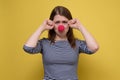 Unhappy young woman pointing with red clown nose crying, looking sad Royalty Free Stock Photo