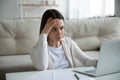 Unhappy woman stressed by slow internet connection on laptop