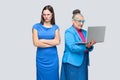 Unhappy young woman standing near happiness older woman work com Royalty Free Stock Photo