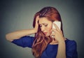 Unhappy young woman talking on mobile phone looking down Royalty Free Stock Photo