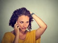 Unhappy young woman talking on mobile phone looking down stressed Royalty Free Stock Photo