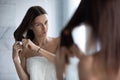 Unhappy woman brush tangled long hair in bathroom Royalty Free Stock Photo