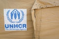UNHCR, the UN Refugee Agency logo on a tent in a refugee camp