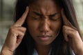 Unhealthy biracial woman suffer from migraine at work
