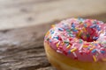 Unhealthy but delicious sweet sugar donut cake on vintage wooden table in lifestyle nutrition health care