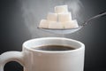 Unhealthy eating concept. Many sugar cubes above hot cup of tea or coffee Royalty Free Stock Photo