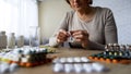 Unhealthy elderly lady drinking pills, vitamins, illness symptoms, hypochondria Royalty Free Stock Photo