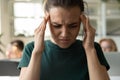 Unhealthy female employee suffer from migraine at workplace Royalty Free Stock Photo