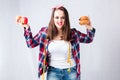 Unhealthy food fat woman concept, girl XXL between healthy and b Royalty Free Stock Photo