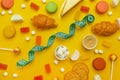 Colorful candies on a bright yellow background. Fast food, junk food. Flat lay, top view. Royalty Free Stock Photo