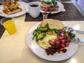 Unhealthy high-calorie breakfast at the Sharm El Sheikh Hotel Egypt. Beans, sausages, pancake, omelette and green pepper with Royalty Free Stock Photo