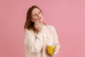 Unhealthy ill blond woman felling toothache after drinking hot or cold beverage, holding cup in hand Royalty Free Stock Photo
