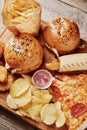Unhealthy and junk food. Different types of fastfood and snacks on the table, closeup. Takeaway food