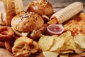 Unhealthy and junk food. Different types of fastfood and snacks on the table, closeup. Takeaway food