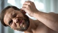 Unhealthy male dripping ear drops, bacterial infection self-treatment, otitis
