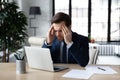 Unhealthy male employee struggle with headache at workplace