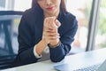 Unhealthy office woman holds her wrist. hand injury, feeling pain. Unhappy woman suffering from pain in office