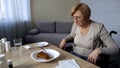 Unhealthy senior woman feeling pain in nursing home, refusing to eat, old age