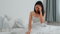 Unhealthy sick Indian female suffers from insomnia. Asian young woman taking painkiller medicine to relieve headache pain.