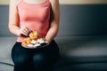 Fit woman snacking with sugary food