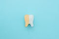Unhealthy tooth white molar model with Clean and dirty tooth before and after whitening on pastel blue background. Tooth symbol