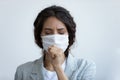 Unhealthy woman in mask coughing having coronavirus disease symptoms
