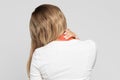 Unhealthy woman with pain in her neck and back, coloured in red, back view. Cervical arthritis, osteochondrosis