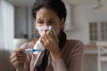Unhealthy young latin woman suffering from flu grippe symptoms. Royalty Free Stock Photo