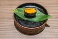 Uni Sushi Japanese food in black plate on wooden table