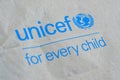 Unicef blue logo on brown paper bag, United Nations Childrens Fund is agency responsible for providing humanitarian and