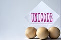 UNICODE - word on a white piece of paper on a white background with wooden balls Royalty Free Stock Photo